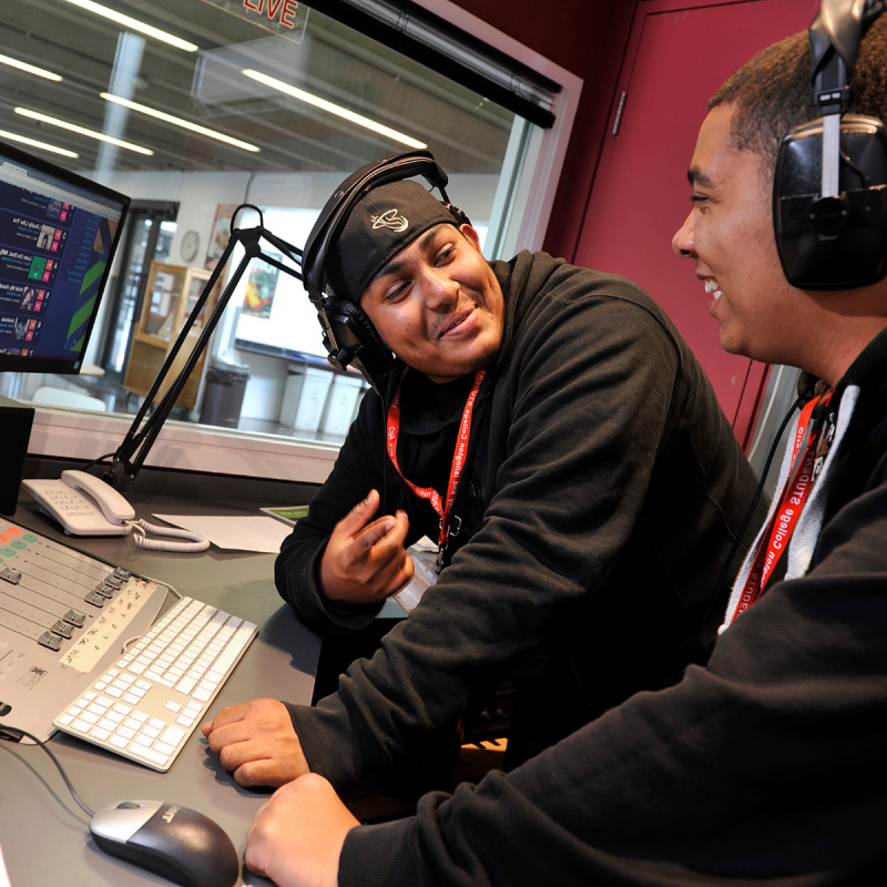 Two young men in a radio station booth