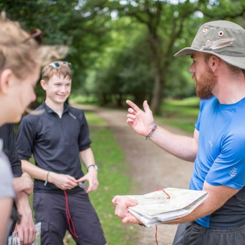 Leader and participants on expedition reading map