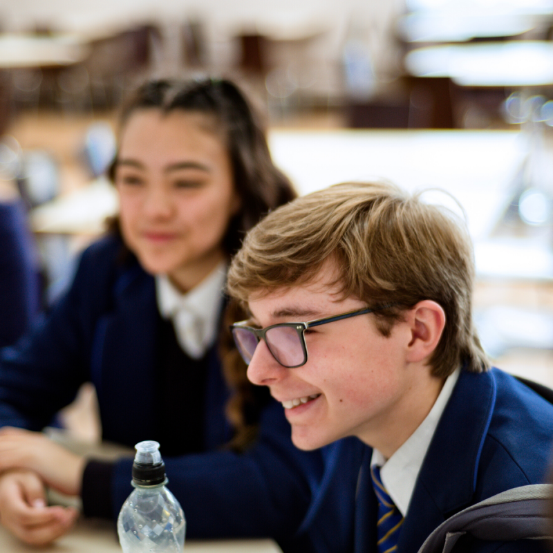 Young male and female students in school uniform